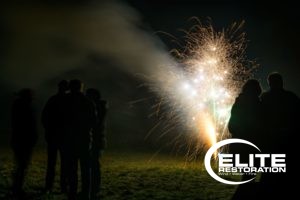Family launching fireworks while practicing fire safety